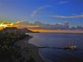 SETTING SUN OVER DIAMOND HEAD ON THE ISLAND OF OAHU-WAIKIKI BEACH IN THE FOREGROUND-