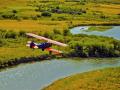 "LOW AND SLOW" -STEARMAN BI-PLANE OVER THE EAST GALLATIN RIVER.  I'M ABOVE SHOOTING HIM FROM THE DOOR OF ANOTHER AIRPLANE