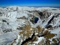 THE BEARTOOTH MOUNTAINS SIT UPON THE LARGEST TRUE HIGH ELEVATION PLATEAU IN THE UNITED STATES=AERIAL 13,000 FEET OPEN DOOR HELICOPTER