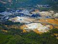 OLD FAITHFUL INN MIDDLE CENTER AND OLD FAITHFUL GEYSER LEFT OF CENTER-YELLOWSTONE NATIONAL PARK - AERIAL
