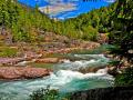 MCDONALD CREEK-GLACIER NATIONAL PARK - THE MAUVE COLORED ROCKS LINE THE CREEK AS THE AQUAMARINE WATER FLOWS GRACEFULLY DOWN HILL